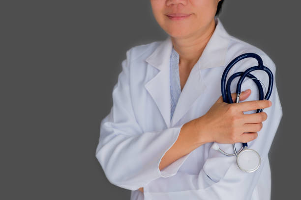 istock Doctor with a stethoscope in the hands on gray background with copy space to write. 854965724