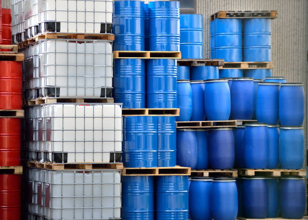 Built for containers Shot of stacked containers in a large distribution warehouse flammable stock pictures, royalty-free photos & images