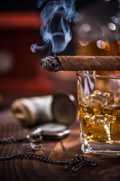 istock Smoke from Cuban Cigar and luxurious items in background 854972574