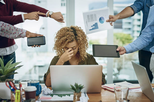 Work commitments are closing in on her Shot of a young businesswoman looking stressed out in a demanding office environment burnout stock pictures, royalty-free photos & images