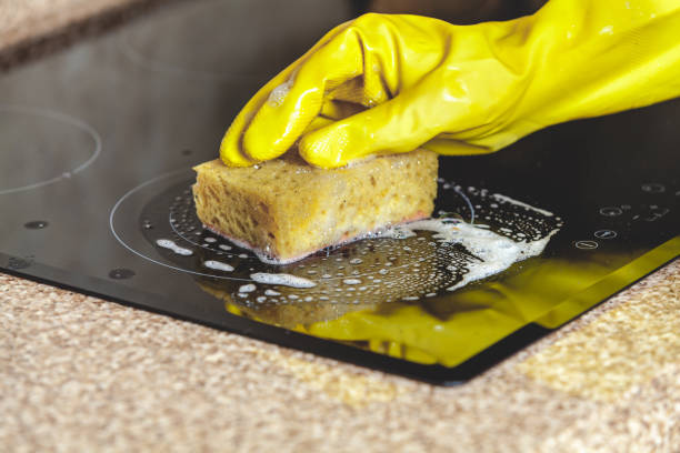 istock Washing electric stove yellow soft sponge 854973152