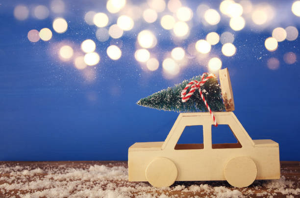 istock Wooden car carrying a christmas tree 854980254