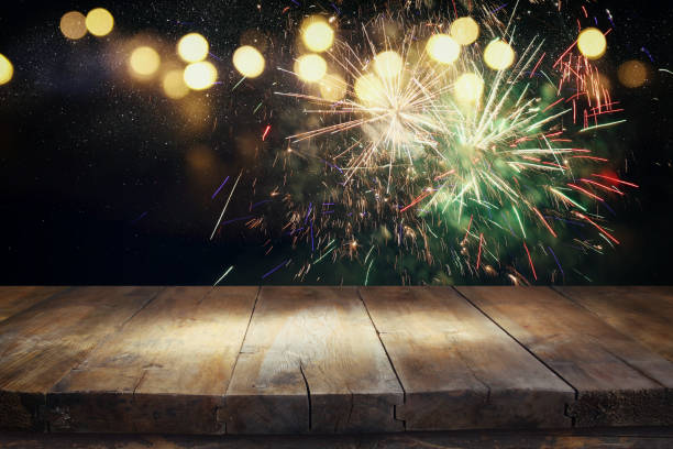istock Empty wooden table in front of fireworks background 854980382