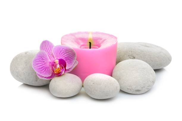 istock orchid, candle, spa stones on white background 854981818