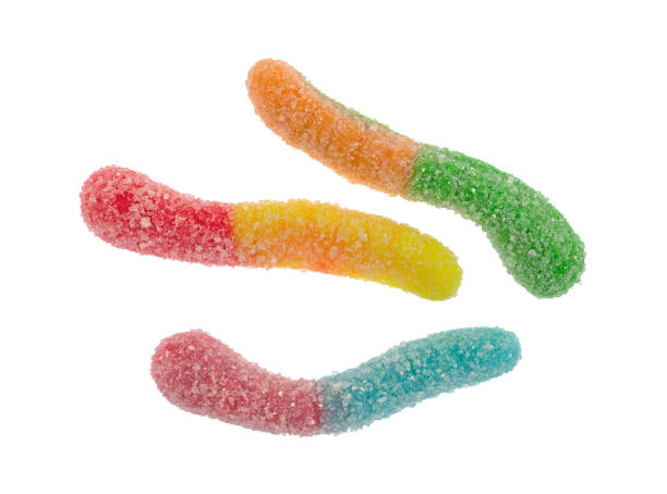 Sugar coated colorful gummy worms Top view of three sugar coated sour tasting colorful gummy worms isolated on a white background. sour taste stock pictures, royalty-free photos & images