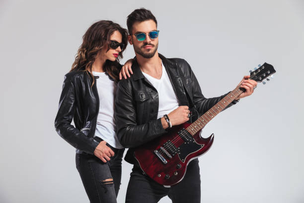 istock woman leaning on man's shoulder while he plays guitar 854988862