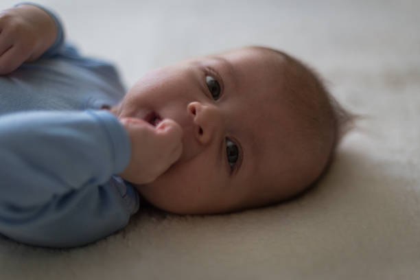 istock Adorable baby lying on bed 854989284