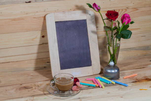 istock slate, pastel and roses on the pinewood table 854992684