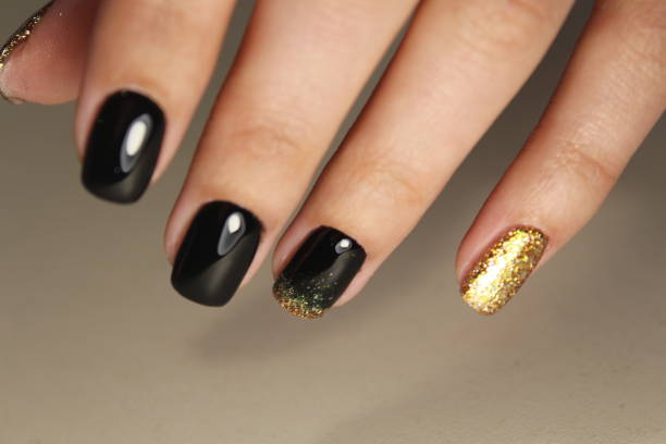 istock manicure design black and gold 854999290
