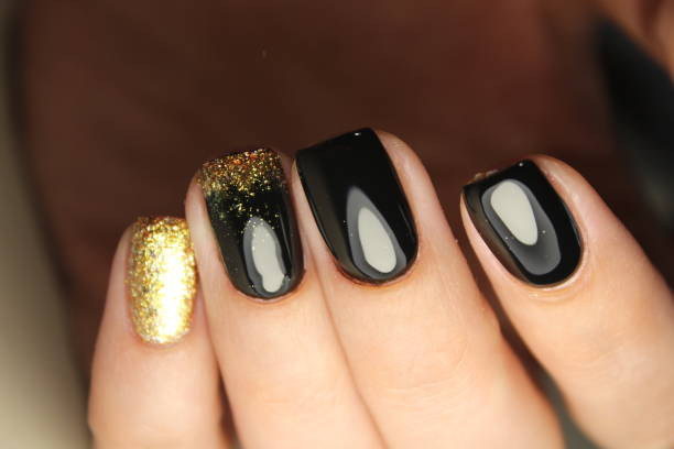 istock manicure design black and gold 854999346