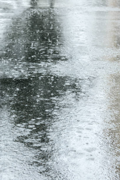 istock wet asphalt sidewalk with puddles during rain 855002570