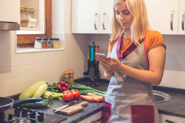istock Smiling beautiful blonde woman using smartphone 855002954