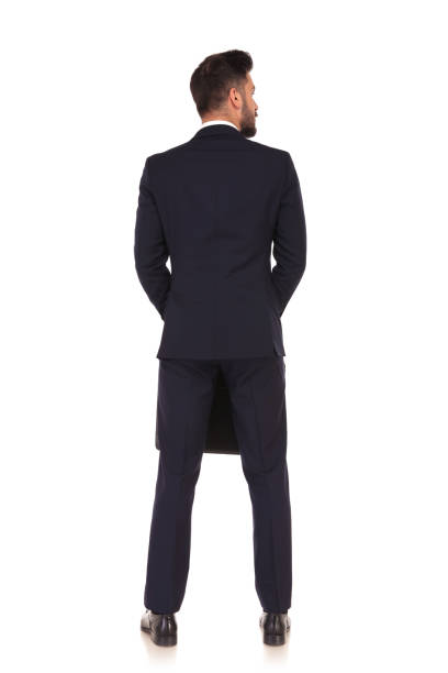 istock back view of a businessman with suitcase looking to side 855003152