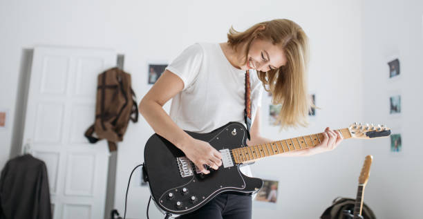 istock Young woman playing guitar 855004006