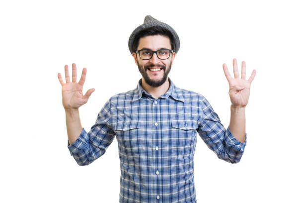 istock Handsome young guy in eyeglasses and hat showing nine on hand 855011396