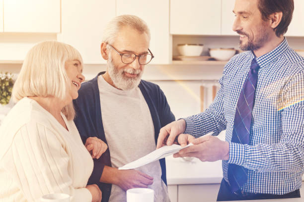 istock Professional real estate agent working with retired couple 855011928