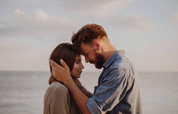 istock Young couple on the sea loving each other 855014118