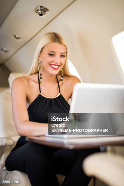 Woman In Private Jet Airplane Stock Photo - Download Image Now - Adult, Adults Only, Airplane