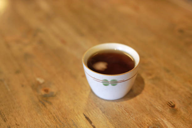 Black long tea on a white background. Top view of dried tea leaves. Tea composition. Ingredients for a hot drink, close-up. Background. Presentation of the type and variety of tea