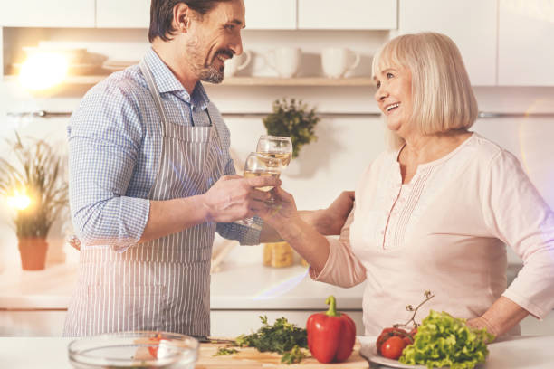 istock Cheerful mother and her adult son drinking wine 855016400