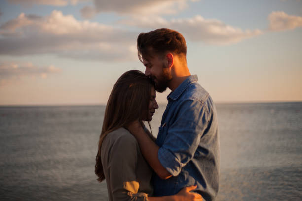 istock Handsome men kissing his girlfriend in the forehead 855019152
