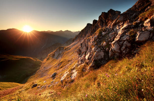 istock gold sunrise in mountains during summer 855022498