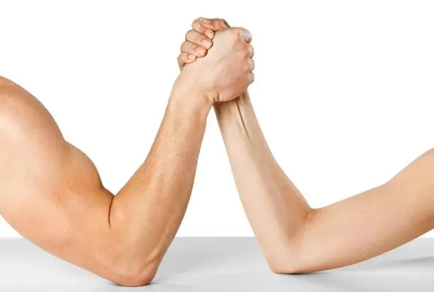 A man and woman with hands clasped arm wrestling Isolated