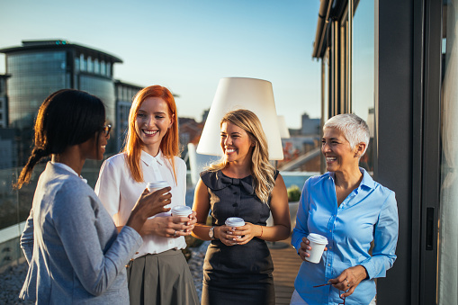Portrait of successful business women drinking coffee.