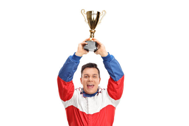 istock Overjoyed car racing champion holding a gold trophy 855031562