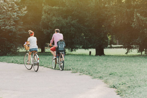 istock Young family riding bicycles in the park 855031704
