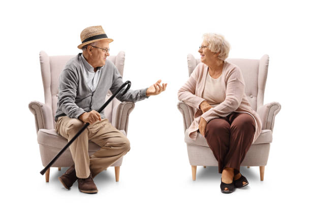 istock Elderly man and elderly woman in armchairs talking 855031840