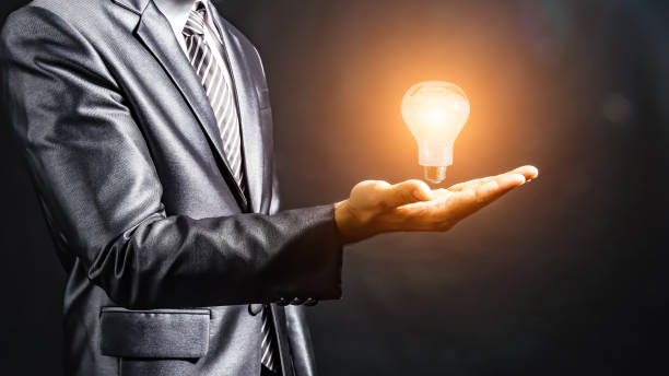 istock Businesswoman holding light bulb on her hands,idea concept.