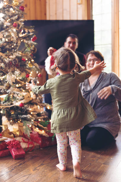 istock Holiday Season : Family decorating the christmas tree 855034872