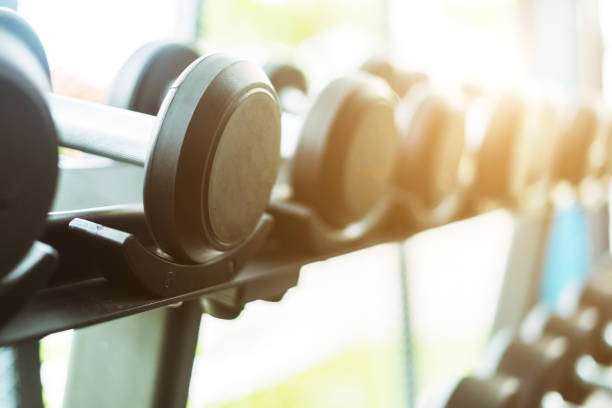 istock Fitness background with dumbbells in gym 855035062