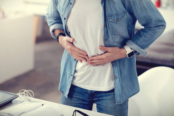 istock Close up of a man holding his stomach 855035146