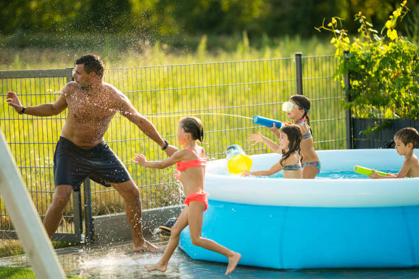istock summer afternoon father children swimming pool 855042348