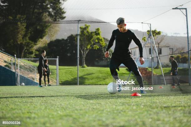 Football Player Practice Dribbling On Field Stock Photo - Download Image Now - Soccer, Sports Training, Soccer Player