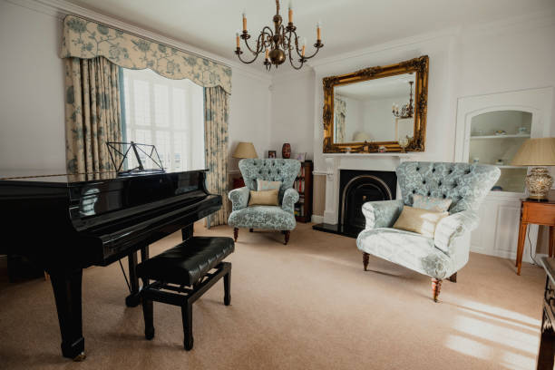 Empty Music Room A traditional looking music room with armchairs and a grand piano. expensive grand piano stock pictures, royalty-free photos & images