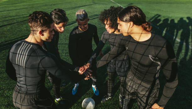 istock Five a side football team putting their hands together 855050536