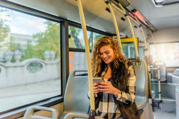 istock Young Woman Typing On Her Smart Phone In Public Transportation. 855054330