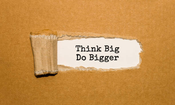istock The text Think Big Do Bigger appearing behind torn brown paper 855054490