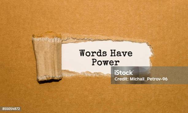 The Text Words Have Power Appearing Behind Torn Brown Paper Stock Photo - Download Image Now