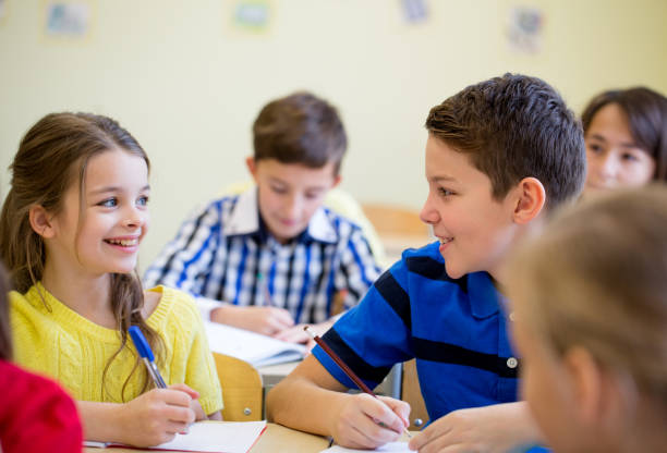 istock group of school kids writing test in classroom 855058142