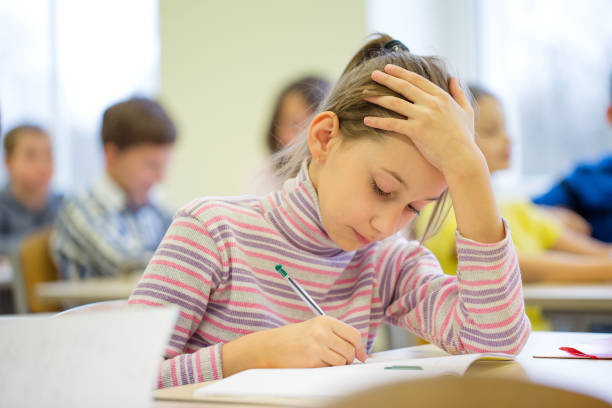 istock group of school kids writing test in classroom 855060734