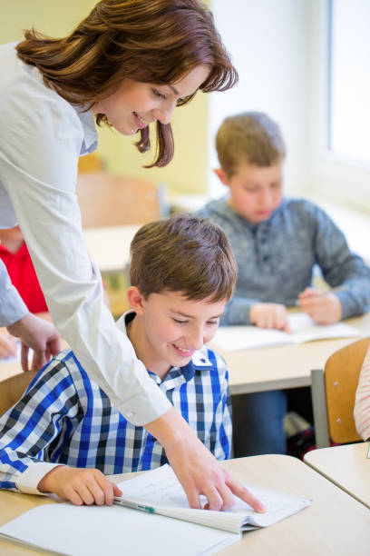 istock group of school kids writing test in classroom 855060990