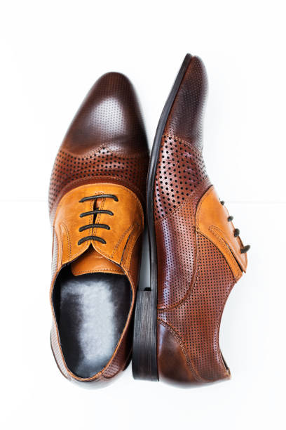 istock Men leather shoe in brown over white 855062628