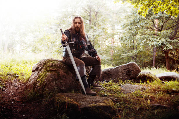 The bearded man knight. A guy in a medieval costume with a sword