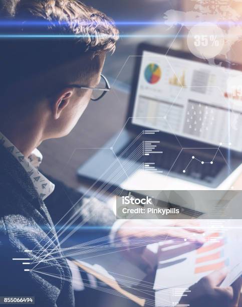 Young Businessman Analyze Stock Report On Notebook Screenconcept Of Digital Screenvirtual Connection Icondiagramgraph Interfaces On Backgroundvertical Stock Photo - Download Image Now