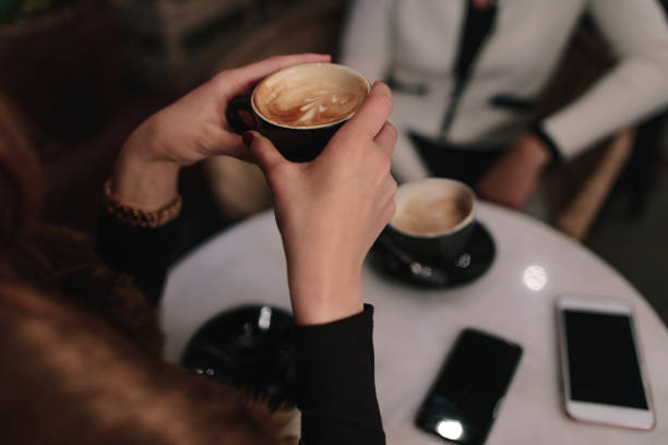 istock Woman having coffee with a friend at cafe 855069268