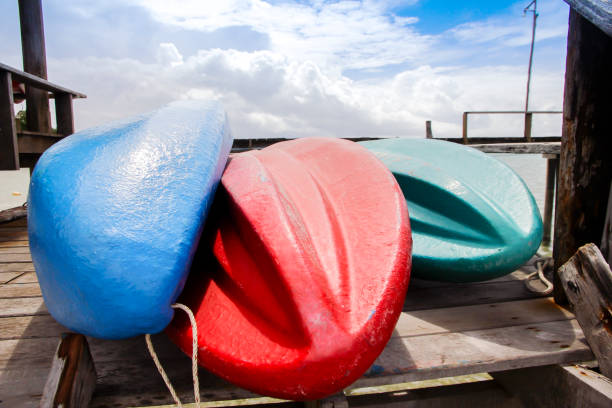 Stock Photo - Long view of colorful kayaks on a wooden docks stock photo